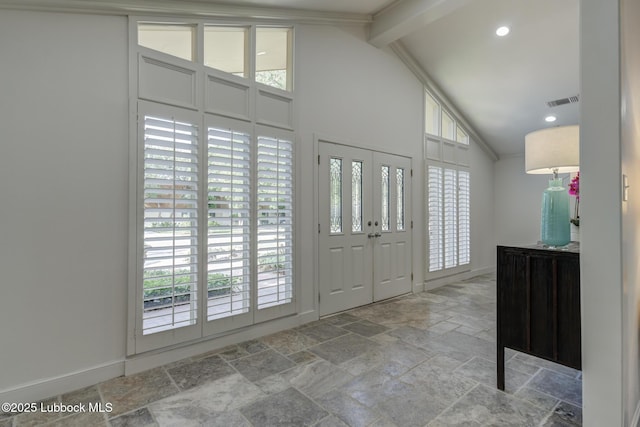 4517 9th St, Lubbock, TX 79416 - entryway featuring stone tile flooring, plenty of natural light, baseboards, beam ceiling, and high vaulted ceiling