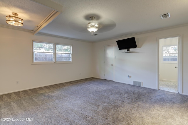 4517 9th St, Lubbock, TX 79416 - carpeted spare room with crown molding, ceiling fan, baseboards, and a textured ceiling