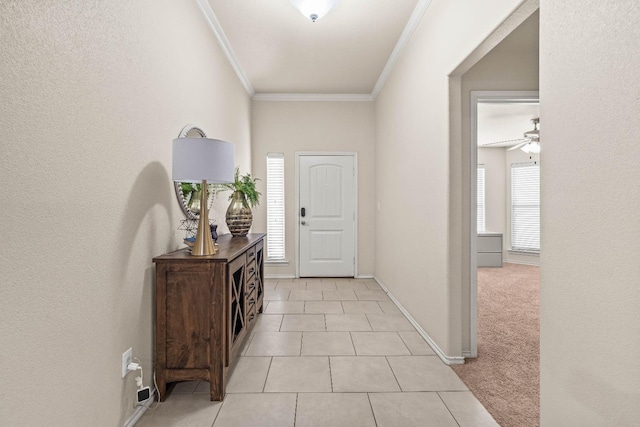 foyer featuring ceiling fan, ornamental molding, and light tile patterned floors