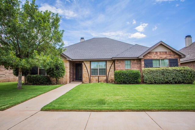 2911 111th St, Lubbock, TX 79423 - view of front of home with a front lawn, roof with shingles, and brick siding