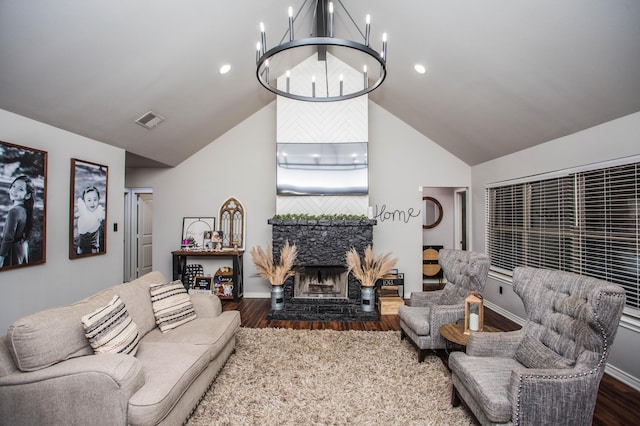 2911 111th St, Lubbock, TX 79423 - living area featuring vaulted ceiling, dark wood-style floors, a chandelier, and a stone fireplace