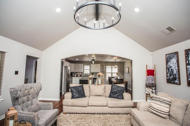 2911 111th St, Lubbock, TX 79423 - living area with arched walkways, a chandelier, wood finished floors, high vaulted ceiling, and recessed lighting