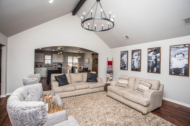 2911 111th St, Lubbock, TX 79423 - living room featuring a chandelier, arched walkways, dark wood finished floors, high vaulted ceiling, and beamed ceiling