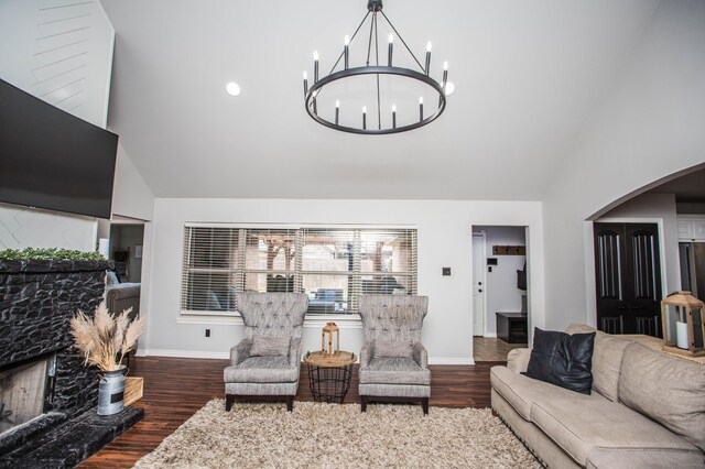 2911 111th St, Lubbock, TX 79423 - living area with wood finished floors, a chandelier, arched walkways, and high vaulted ceiling