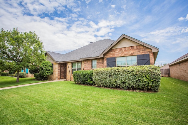 2911 111th St, Lubbock, TX 79423 - ranch-style home with brick siding, a front lawn, and a shingled roof