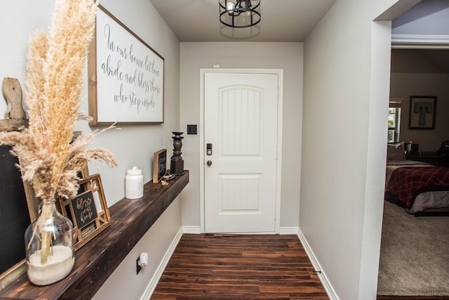 2911 111th St, Lubbock, TX 79423 - doorway with dark wood-style floors and a chandelier