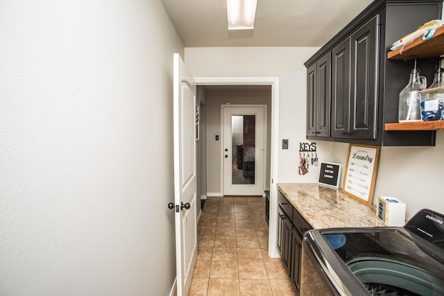 2911 111th St, Lubbock, TX 79423 - laundry area with cabinet space, independent washer and dryer, and light tile patterned floors