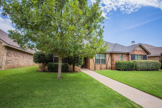 2911 111th St, Lubbock, TX 79423 - view of front of house with a front lawn, brick siding, a chimney, and roof with shingles