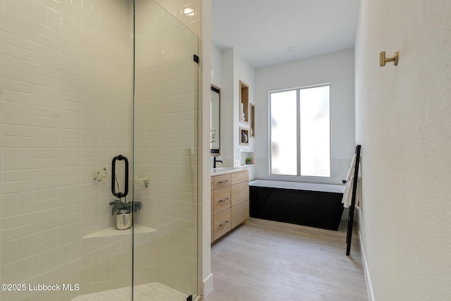 3817 128th St, Lubbock, TX 79423 - bathroom featuring a stall shower, vanity, and wood finished floors