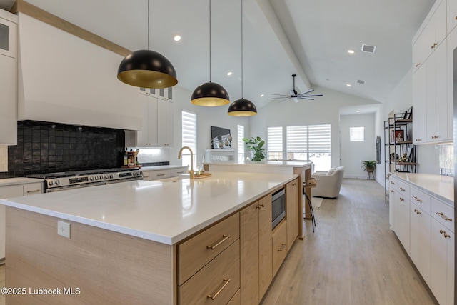 3817 128th St, Lubbock, TX 79423 - kitchen with appliances with stainless steel finishes, light wood-type flooring, backsplash, light countertops, and recessed lighting