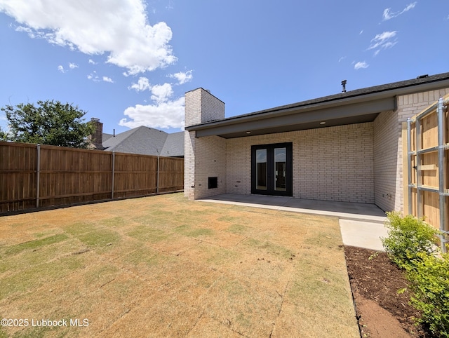 3817 128th St, Lubbock, TX 79423 - rear view of property featuring brick siding, french doors, a patio area, and a chimney