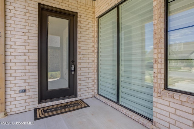 3817 128th St, Lubbock, TX 79423 - view of exterior entry featuring brick siding and a porch