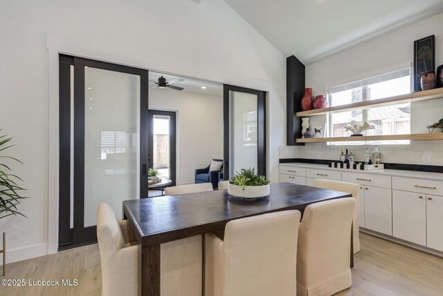 3817 128th St, Lubbock, TX 79423 - dining room with light wood finished floors, lofted ceiling, ceiling fan, and bar