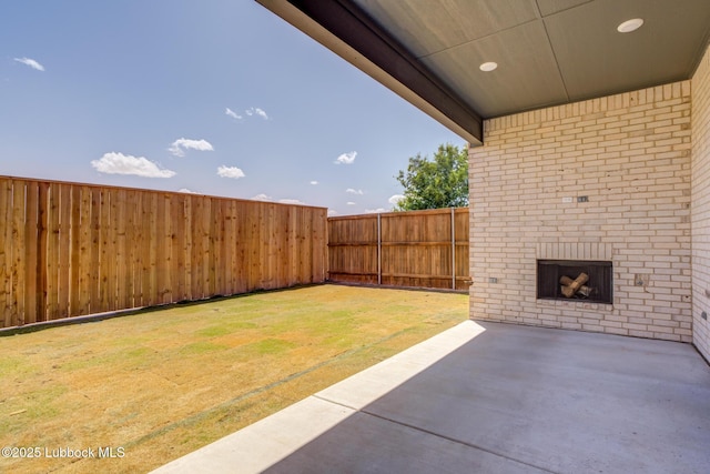 3817 128th St, Lubbock, TX 79423 - fenced backyard with an outdoor brick fireplace and a patio
