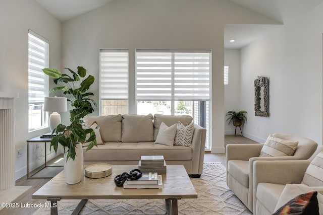3817 128th St, Lubbock, TX 79423 - living area featuring vaulted ceiling, plenty of natural light, and light wood-style flooring