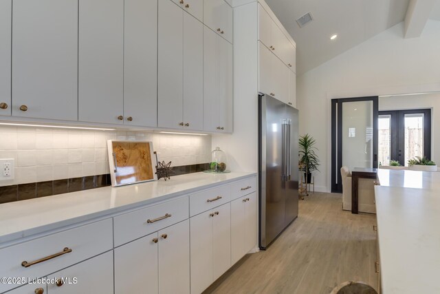 3817 128th St, Lubbock, TX 79423 - kitchen with high quality fridge, light countertops, light wood-style flooring, decorative backsplash, and white cabinets