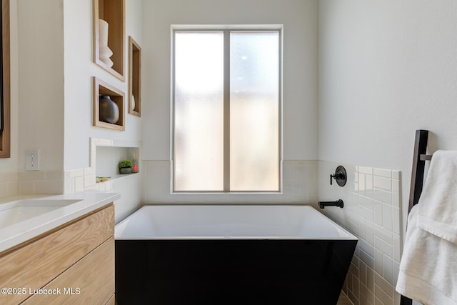 3817 128th St, Lubbock, TX 79423 - full bath with a tub to relax in, vanity, and tile walls