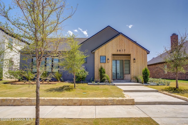 3817 128th St, Lubbock, TX 79423 - view of front of house featuring a front yard and board and batten siding