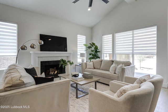 3817 128th St, Lubbock, TX 79423 - living room with light wood-style flooring, a ceiling fan, a brick fireplace, and high vaulted ceiling