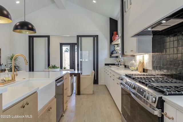 3817 128th St, Lubbock, TX 79423 - kitchen with appliances with stainless steel finishes, light wood-style flooring, light countertops, custom range hood, and backsplash