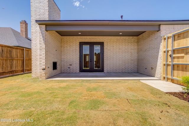 3817 128th St, Lubbock, TX 79423 - rear view of property with a patio, brick siding, and french doors