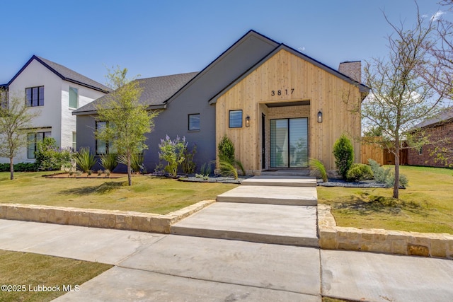3817 128th St, Lubbock, TX 79423 - view of front facade with a chimney and a front yard