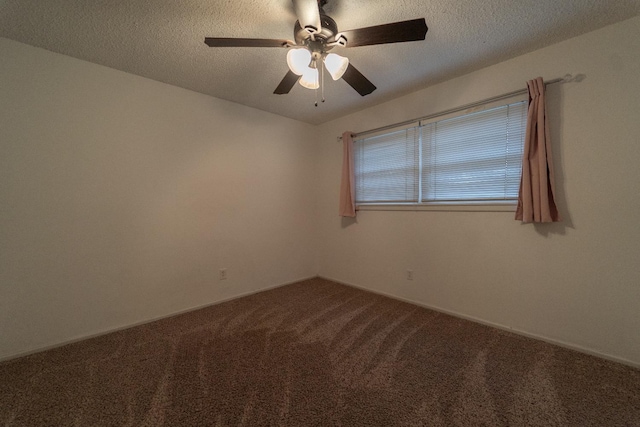 carpeted empty room with ceiling fan and a textured ceiling