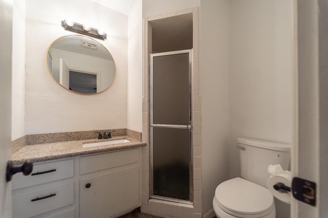 bathroom featuring walk in shower, vanity, and toilet