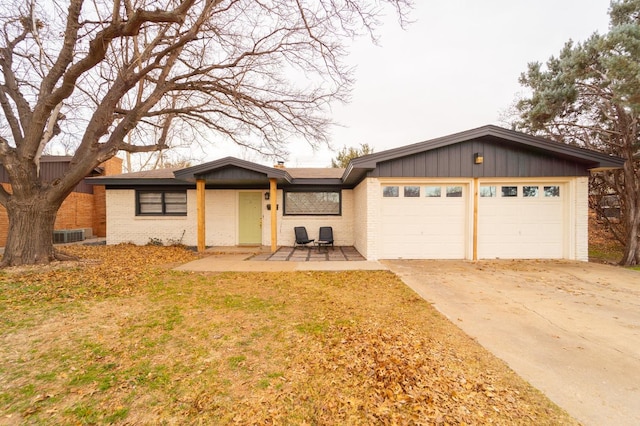 ranch-style house with a garage and a front lawn