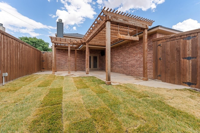 back of property featuring a pergola, a yard, and a patio area