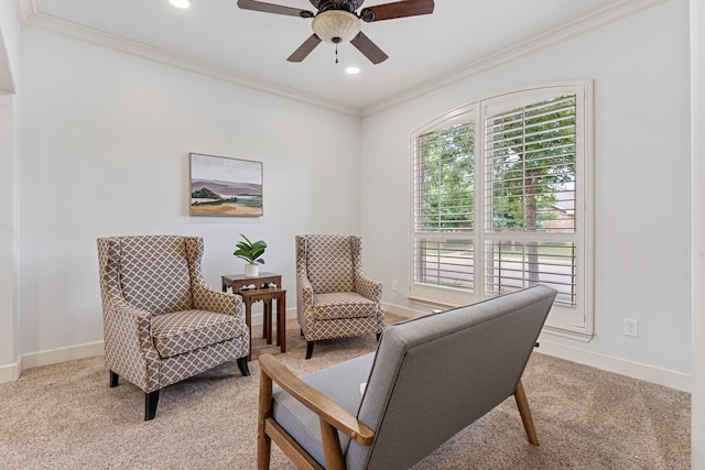 sitting room with crown molding, light colored carpet, and ceiling fan