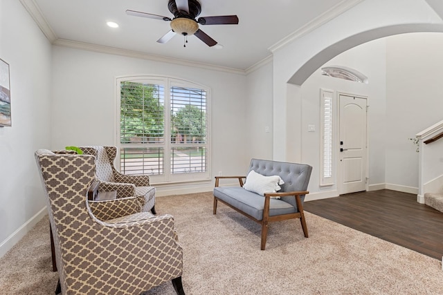 sitting room featuring hardwood / wood-style flooring, ornamental molding, and ceiling fan