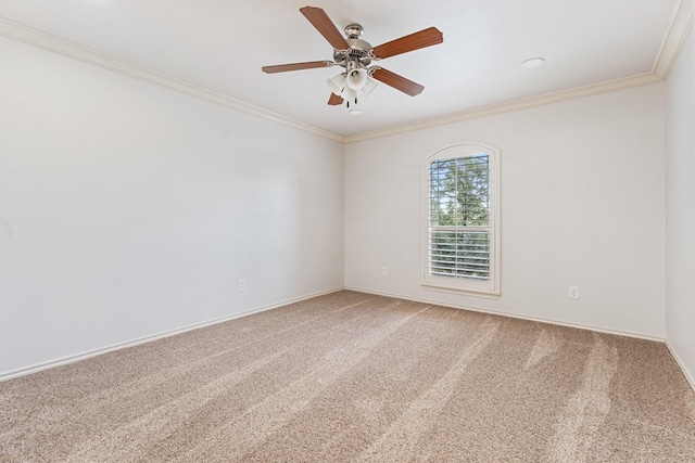 carpeted spare room featuring ornamental molding and ceiling fan