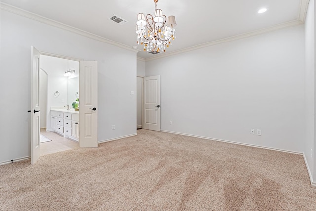 carpeted spare room with ornamental molding and an inviting chandelier