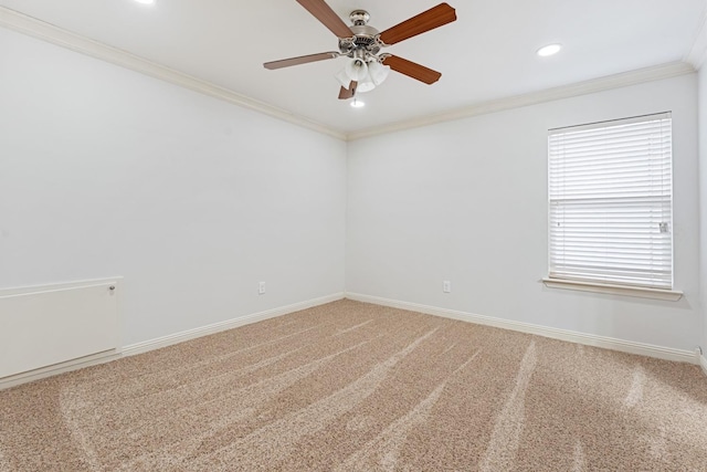 carpeted spare room with ornamental molding and ceiling fan