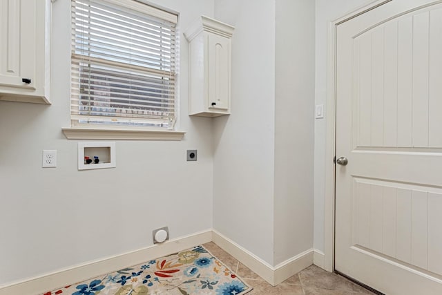 laundry area featuring cabinets, light tile patterned floors, hookup for a washing machine, and hookup for an electric dryer