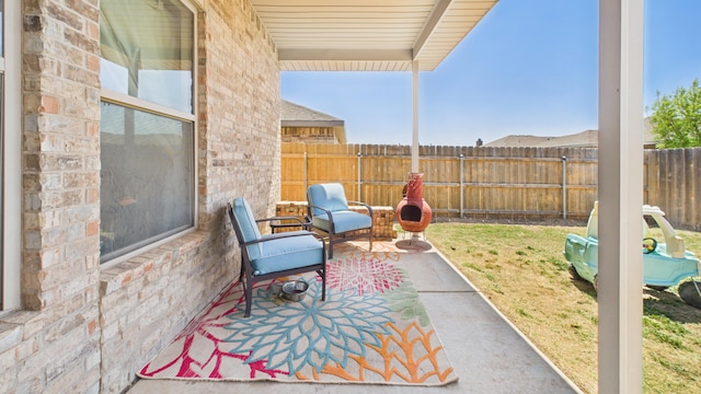 view of patio featuring fence