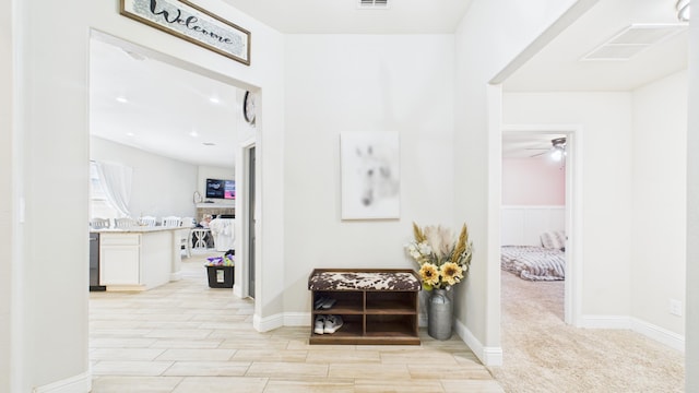hallway with visible vents and wood tiled floor