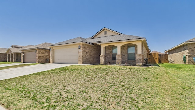 single story home with concrete driveway, fence, brick siding, a front lawn, and a garage