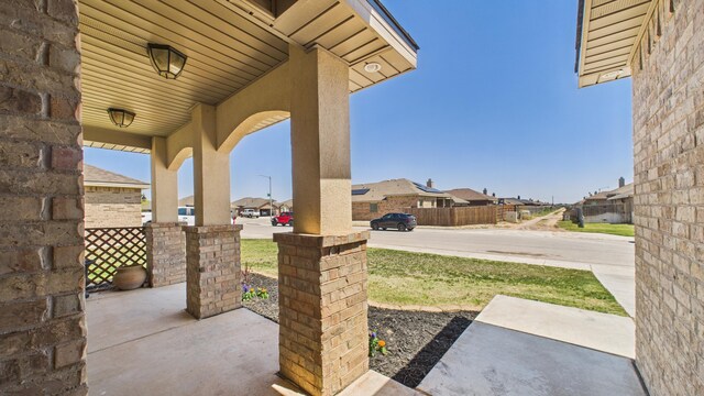 view of patio / terrace with a porch and a residential view