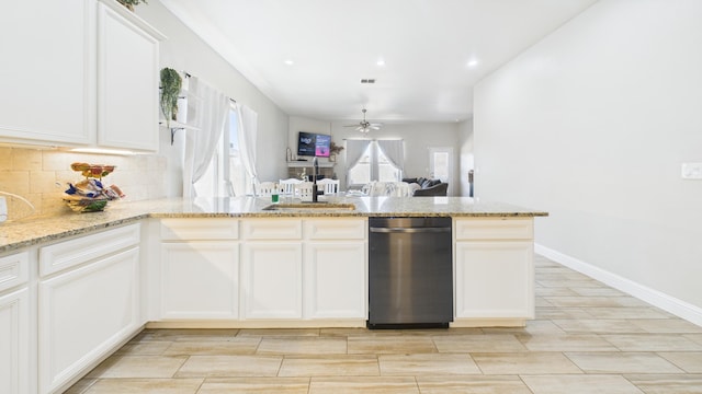 kitchen featuring tasteful backsplash, white cabinets, ceiling fan, light stone countertops, and dishwasher