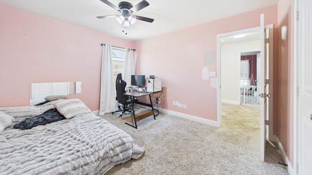 carpeted bedroom featuring ceiling fan and baseboards
