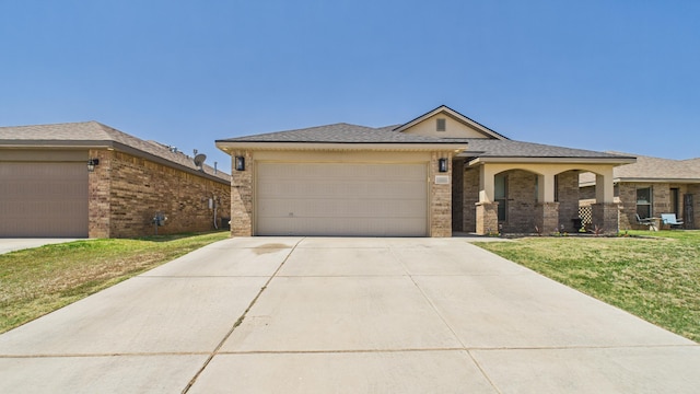 ranch-style home with brick siding, a front yard, concrete driveway, and an attached garage
