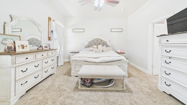 bedroom featuring baseboards, a ceiling fan, and light colored carpet