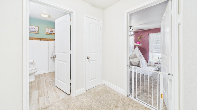 hallway featuring baseboards