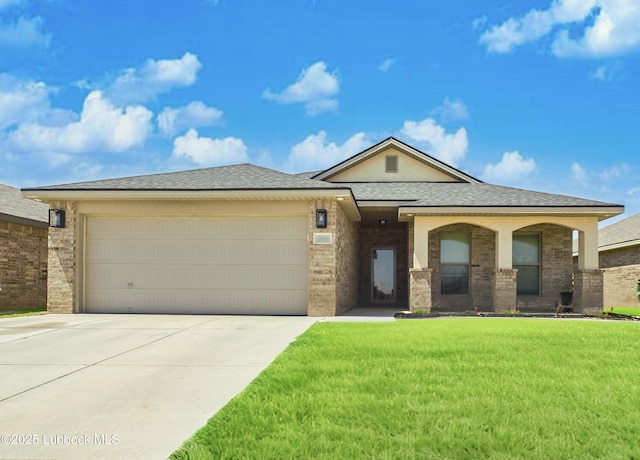 view of front facade with brick siding, a garage, driveway, roof with shingles, and a front yard