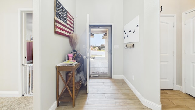 foyer with wood finish floors and baseboards