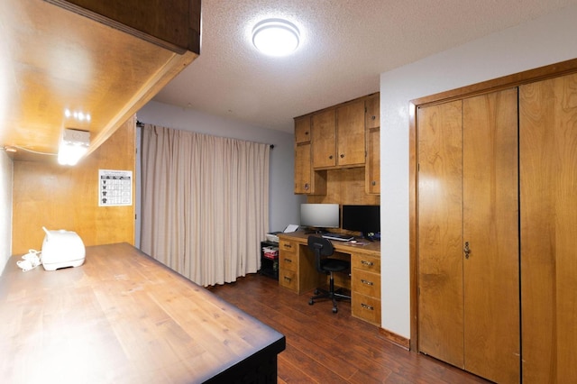 office with dark hardwood / wood-style flooring and a textured ceiling