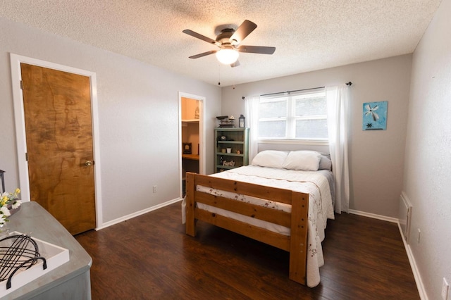 bedroom featuring dark hardwood / wood-style flooring, ceiling fan, a textured ceiling, and ensuite bathroom