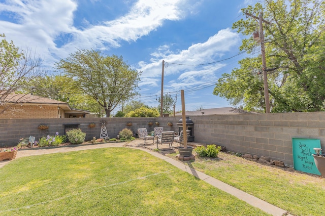 view of yard with a patio and a fenced backyard